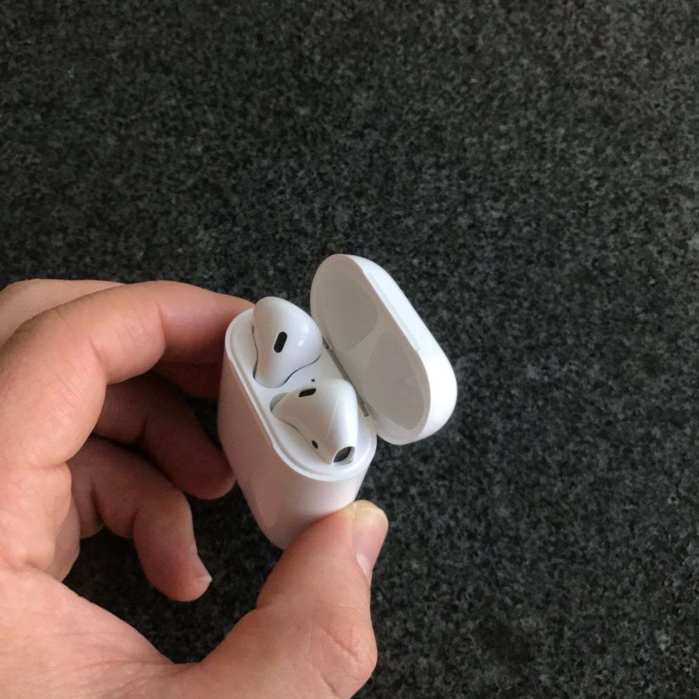 Apple AirPods inside charging case, and open